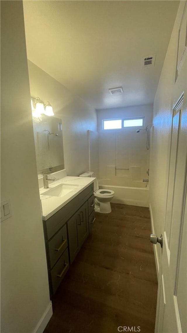 bathroom featuring shower / tub combination, vanity, toilet, wood finished floors, and visible vents