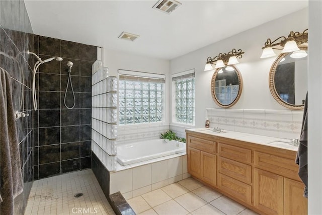 bathroom featuring a tile shower, double vanity, tile patterned floors, visible vents, and a bath