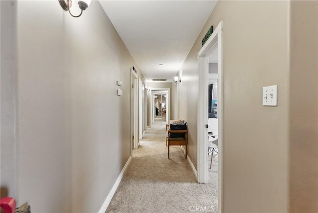 hall with baseboards and carpet