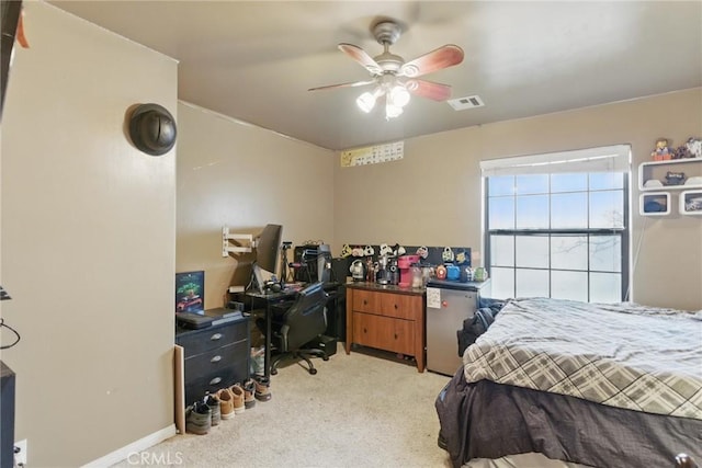bedroom featuring light colored carpet, ceiling fan, and visible vents
