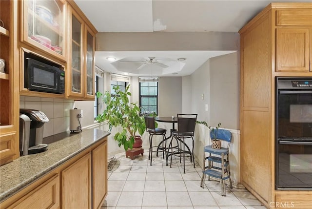 24980 Sunset Way, Tehachapi, CA 93561 - kitchen with black appliances, a ceiling fan, light stone countertops, glass insert cabinets, and light tile patterned floors