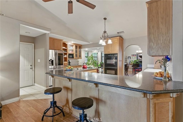 24980 Sunset Way, Tehachapi, CA 93561 - kitchen featuring black appliances, ceiling fan, lofted ceiling, a peninsula, and glass insert cabinets