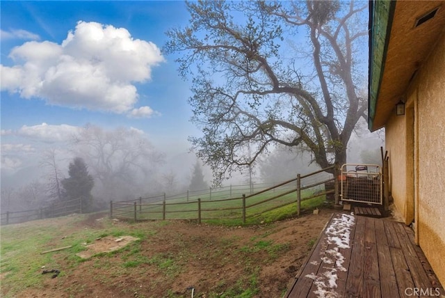 view of yard with a rural view and fence