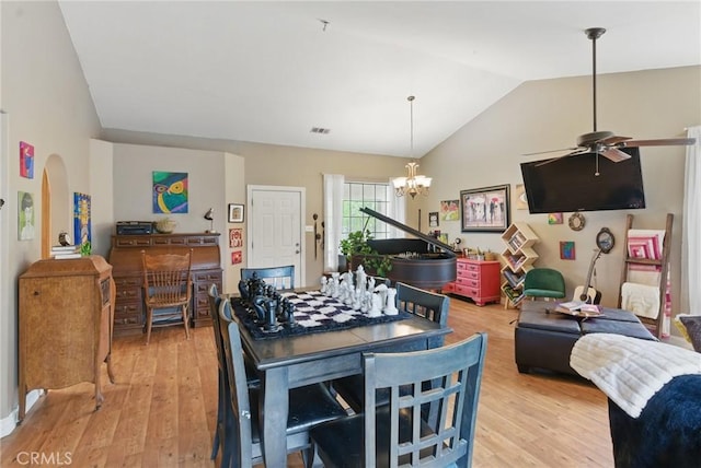 24980 Sunset Way, Tehachapi, CA 93561 - dining room with ceiling fan, vaulted ceiling, light wood-style floors, arched walkways, and a chandelier