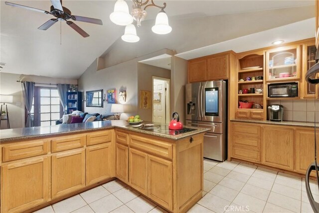 kitchen featuring vaulted ceiling, black appliances, light tile patterned flooring, and open floor plan