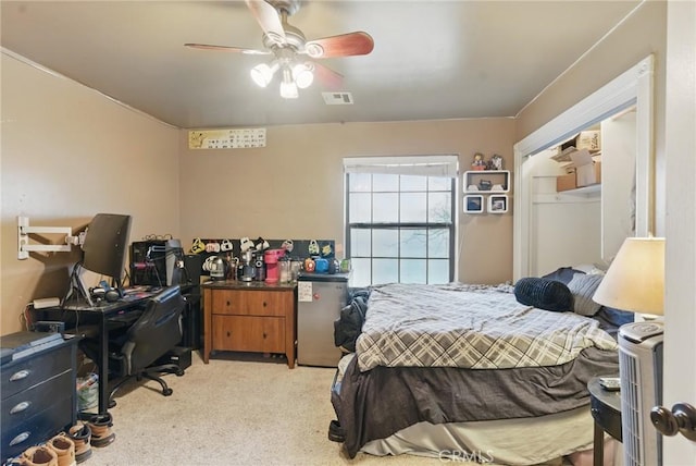 bedroom with ceiling fan, light colored carpet, and visible vents