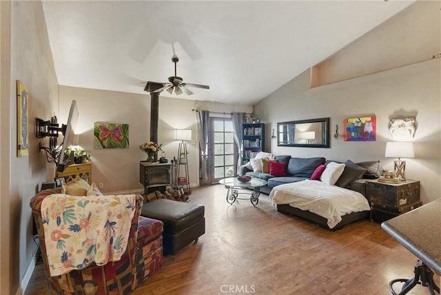 24980 Sunset Way, Tehachapi, CA 93561 - living room with a wood stove, lofted ceiling, wood finished floors, and ceiling fan