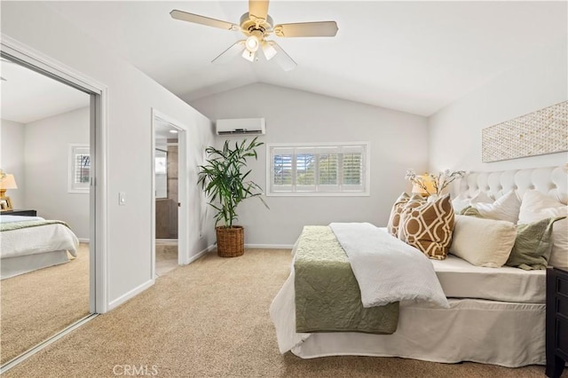 carpeted bedroom featuring an AC wall unit, a ceiling fan, baseboards, ensuite bathroom, and lofted ceiling