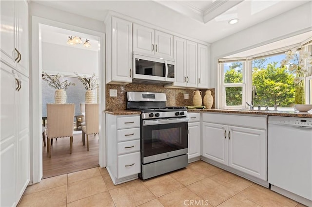 kitchen with decorative backsplash, white cabinetry, light tile patterned floors, recessed lighting, and white appliances