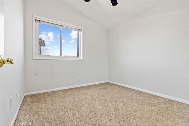 carpeted empty room with a ceiling fan, baseboards, and lofted ceiling