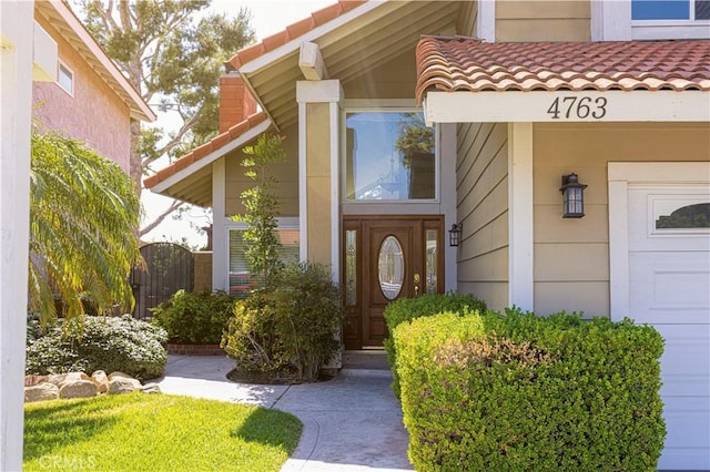 entrance to property with a gate and a tiled roof