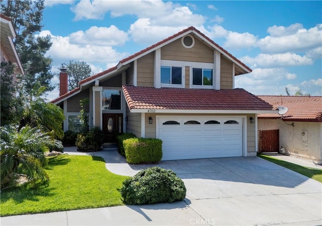 view of front of home with a garage, a front yard, a chimney, a tiled roof, and driveway
