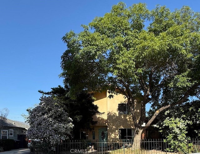 view of property exterior featuring fence private yard and stucco siding