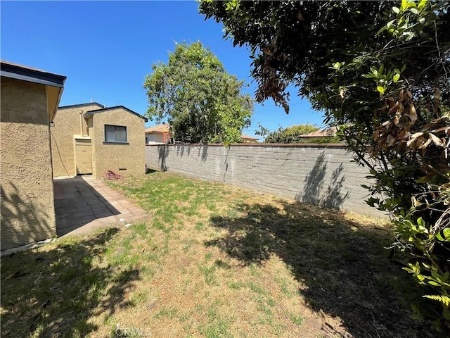 view of yard with a patio and a fenced backyard