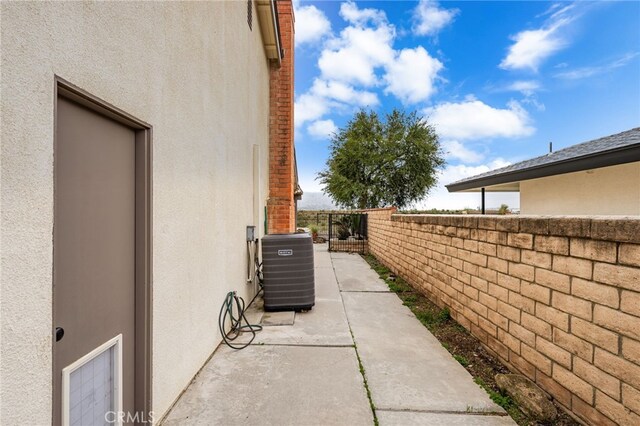 1530 Greenbriar Ave, Corona, CA 92878 - view of property exterior featuring central air condition unit, stucco siding, fence, and a patio