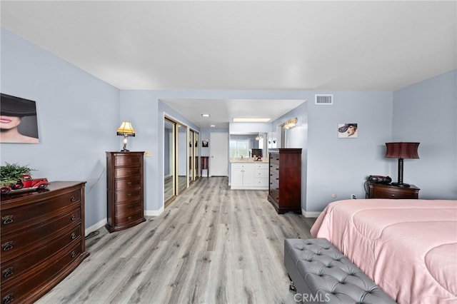 1530 Greenbriar Ave, Corona, CA 92878 - bedroom with connected bathroom, visible vents, light wood-style flooring, and baseboards
