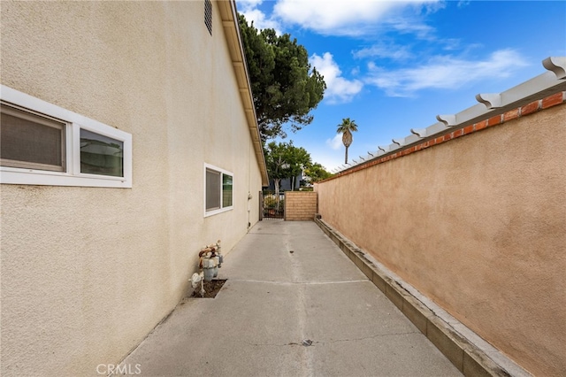 1530 Greenbriar Ave, Corona, CA 92878 - view of property exterior with stucco siding, fence, and a patio