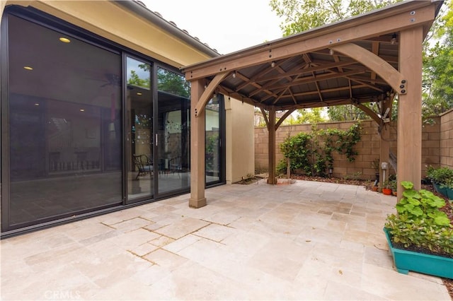 view of patio with a gazebo and fence