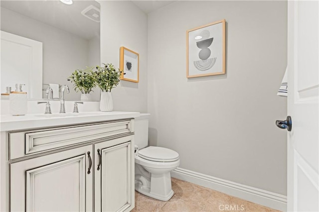 bathroom with toilet, baseboards, tile patterned flooring, and vanity