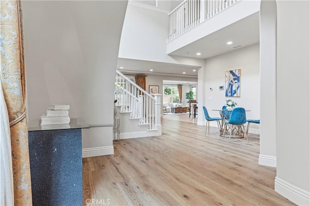 foyer with stairs, recessed lighting, baseboards, and wood finished floors