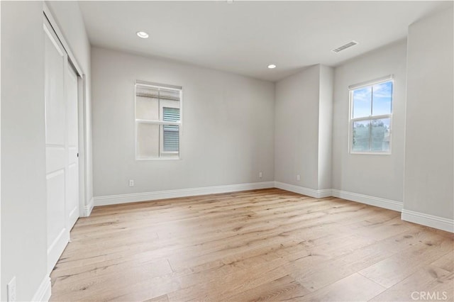 unfurnished bedroom featuring recessed lighting, light wood finished floors, and visible vents