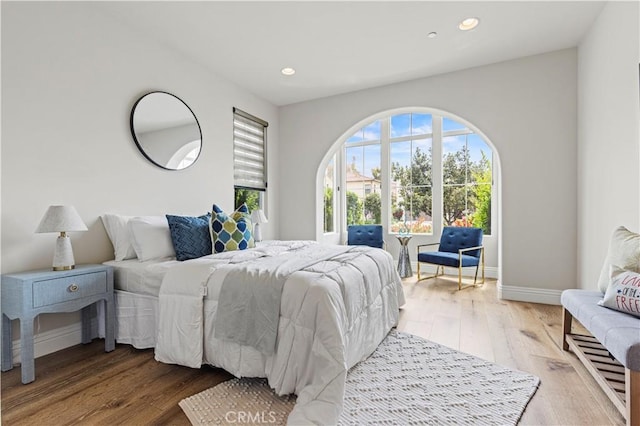 bedroom featuring baseboards, recessed lighting, and wood finished floors
