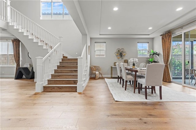 dining space featuring stairs, recessed lighting, baseboards, and wood finished floors