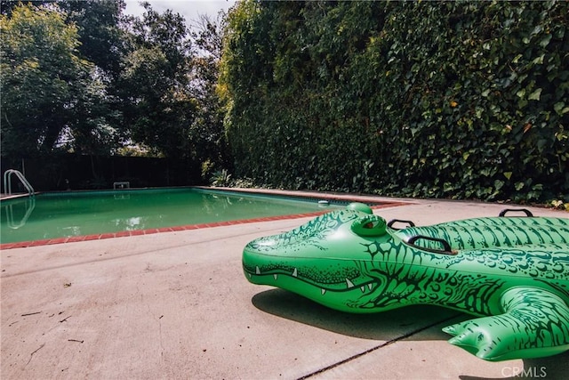 outdoor pool featuring a patio