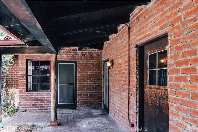 property entrance featuring brick siding