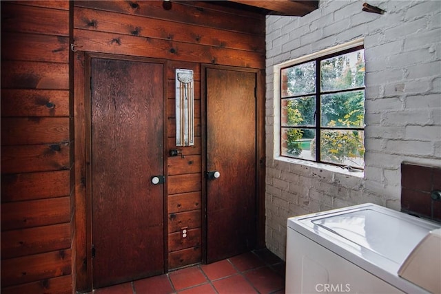washroom featuring laundry area, washer / dryer, and tile patterned flooring