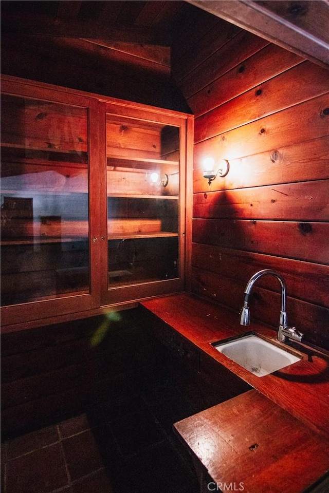 interior space featuring wood walls and a sink