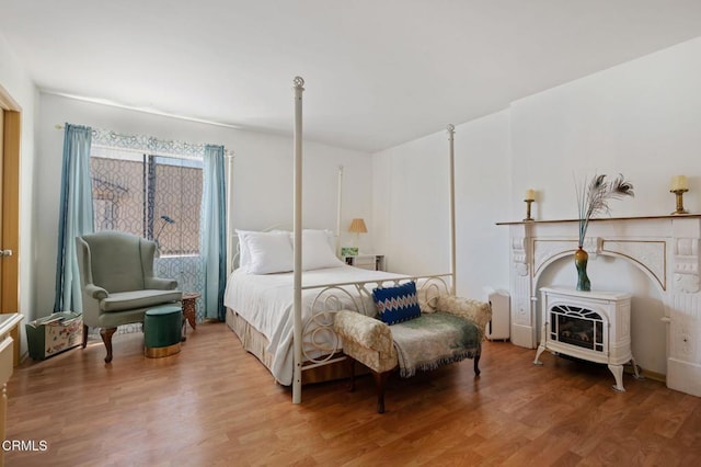 543 S E St, Oxnard, CA 93030 - bedroom featuring wood finished floors and a wood stove