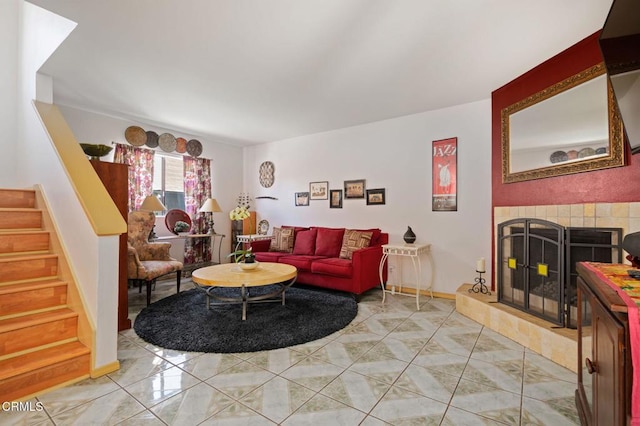 543 S E St, Oxnard, CA 93030 - living area with stairs, a tiled fireplace, light tile patterned flooring, and baseboards