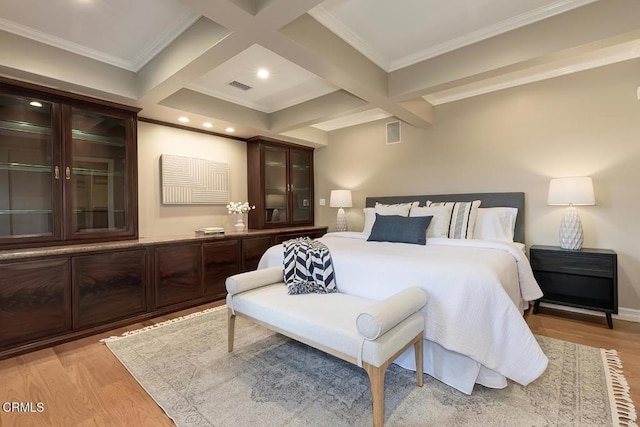 bedroom featuring visible vents, light wood-style flooring, beam ceiling, and coffered ceiling