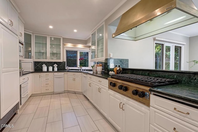 kitchen featuring ornamental molding, decorative backsplash, a healthy amount of sunlight, and stainless steel gas stovetop