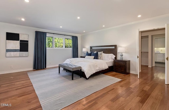 bedroom with crown molding, baseboards, light wood-style floors, and recessed lighting