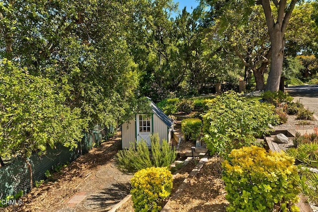 view of yard featuring an outdoor structure and a shed