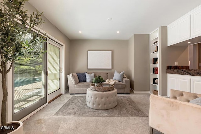 living room with baseboards, recessed lighting, and light colored carpet