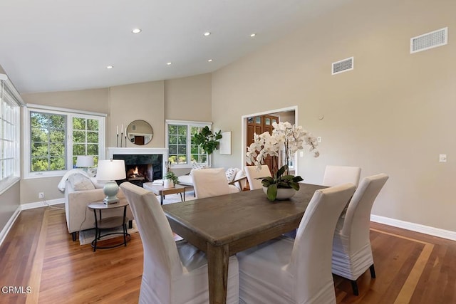 dining space with baseboards, wood finished floors, and visible vents