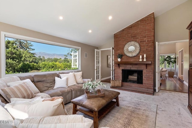 living room with recessed lighting, high vaulted ceiling, and a healthy amount of sunlight