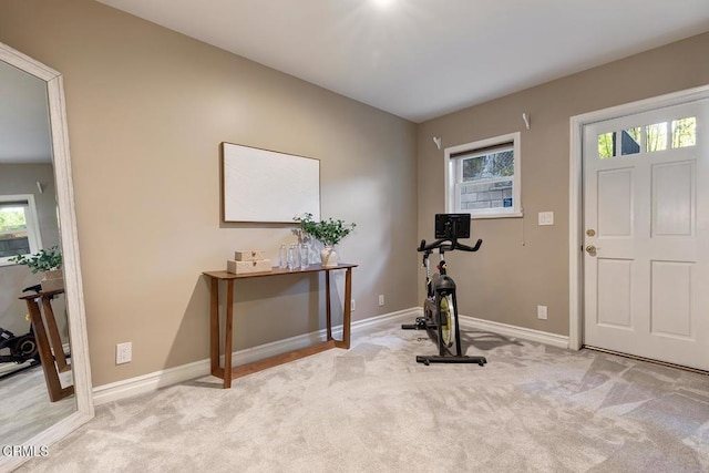 workout room with carpet flooring, baseboards, and a wealth of natural light