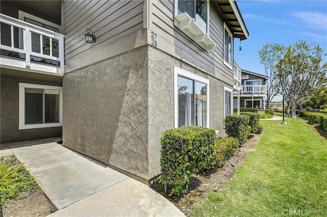 view of home's exterior featuring a yard and stucco siding