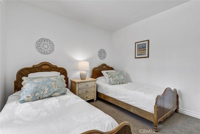 carpeted bedroom featuring baseboards