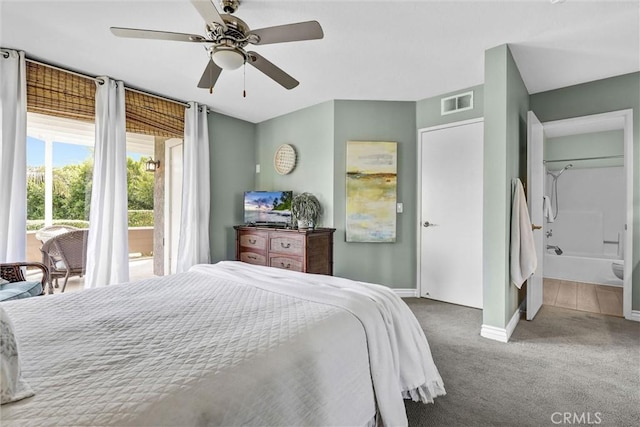 bedroom with visible vents, baseboards, ceiling fan, carpet flooring, and ensuite bath