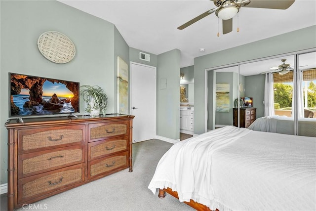 bedroom featuring ceiling fan, visible vents, baseboards, a closet, and light carpet