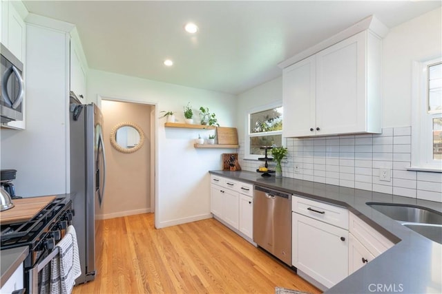 kitchen with dark countertops, open shelves, stainless steel appliances, and backsplash