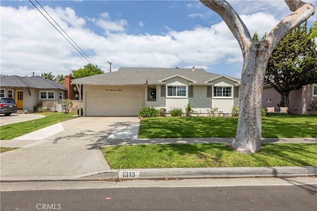 ranch-style house featuring an attached garage, concrete driveway, and a front yard