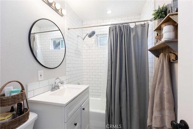 bathroom with backsplash, shower / bath combo with shower curtain, and vanity