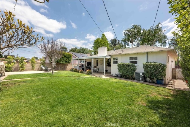back of house featuring a fenced backyard, stucco siding, a patio area, central air condition unit, and a yard