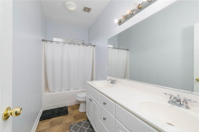 bathroom featuring a sink, toilet, double vanity, and visible vents